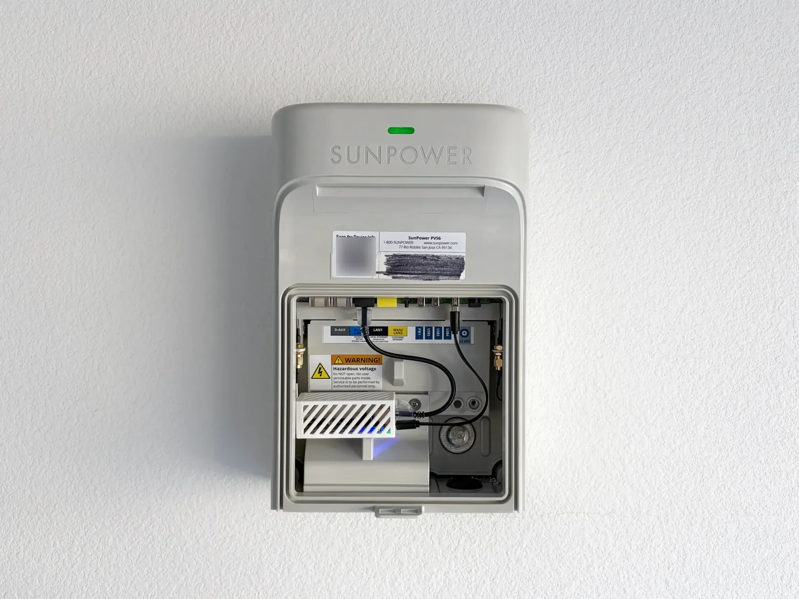 The Solar Monitor's status LED glowing solid blue inside the PVS after joining the home Wi-Fi.